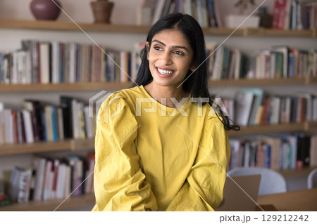 Pensive Indian woman take break in office or library 129212242