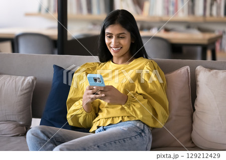 Indian worker or student woman using her smartphone during break 129212429