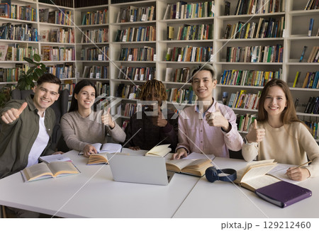 Team portrait smiling multiethnic students showing thumbs up to camera 129212460