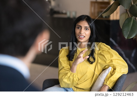 Focus on Indian professional woman engaged in conversation or discussion 129212463