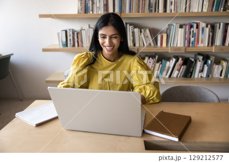 Employee working on studying sit at table with laptop 129212577