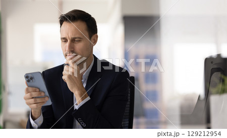 Business man sit in workplace using smartphone 129212954