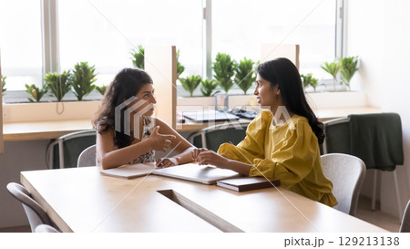 Two Indian colleagues working on joint task 129213138