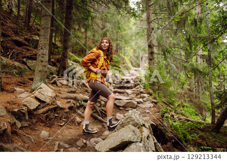 Young woman with backpack traveling outdoors. Hiking, active lifestyle. Young woman with backpack traveling outdoors. Hiking, active lifestyle. 129213344