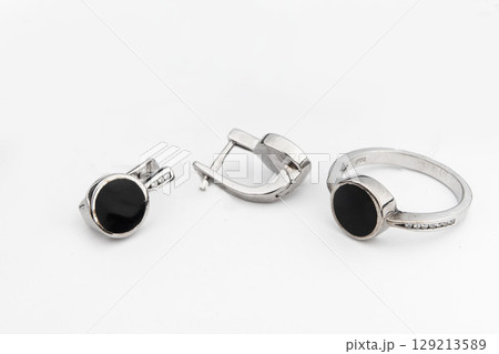 Silver jewelry set of ring and silver earrings with stones on white background. Silver jewelry set collection 129213589