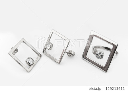 Silver jewels collection with crystals in minimalism style. Silver set of earrings and silver necklace Silver jewels collection with crystals in minimalism style. Silver set of earrings and silver necklace 129213611