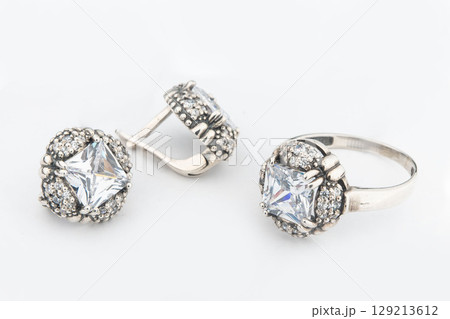 Silver jewels collection with crystals in minimalism style. Silver set of earrings and silver necklace Silver jewels collection with crystals in minimalism style. Silver set of earrings and silver necklace 129213612