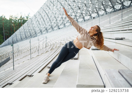 A young female athlete in special clothing is training on the court. Concept of sport, health. A young female athlete in special clothing is training on the court. Concept of sport, health. 129213738