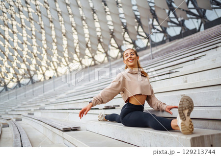 A young female athlete in special clothing is training on the court. Concept of sport, health. 129213744