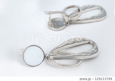 Luxury silver round earrings big jewelry for women isolated on white background, clipping path included Luxury silver round earrings big jewelry for women isolated on white background, clipping path included 129213789