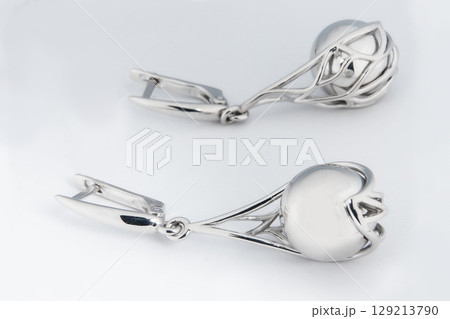 Luxury silver round earrings big jewelry for women isolated on white background, clipping path included Luxury silver round earrings big jewelry for women isolated on white background, clipping path included 129213790