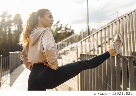 A young female athlete in special clothing is training on the court. Concept of sport, health. A young female athlete in special clothing is training on the court. Concept of sport, health. 129213829