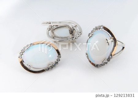 Elegant jewelry set of white gold ring, necklace and earrings with diamonds. Silver jewellery set with gemstones. Product still life concept 129213831