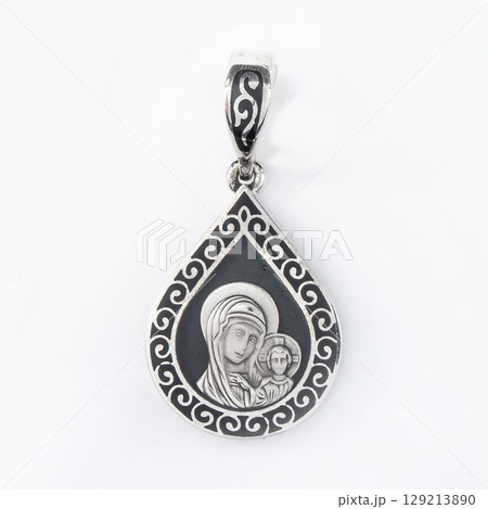 Gold pendant with the Virgin Mary christian symbol isolated on white 129213890