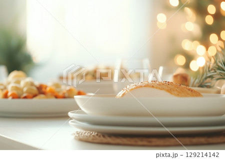 Festive holiday meal setting with roasted turkey breast and seasonal side dishes on a decorated table in soft warm lighting, AI Generative 129214142