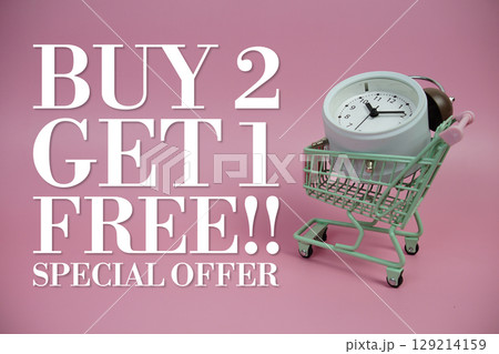 Buy 2 Get 1 Free!! Promotion and Marketing with trolley shopping cart and alarm clock on pink background Buy 2 Get 1 Free!! Promotion and Marketing with trolley shopping cart and alarm clock on pink background 129214159