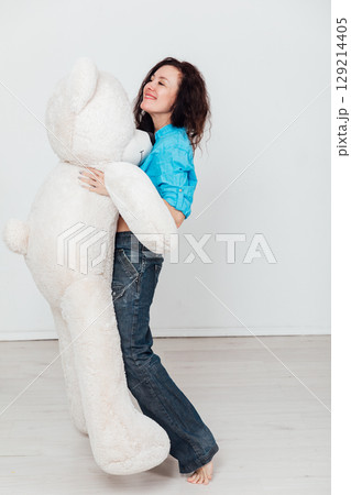 woman in jeans with a polar bear gift woman in jeans with a polar bear gift 129214405