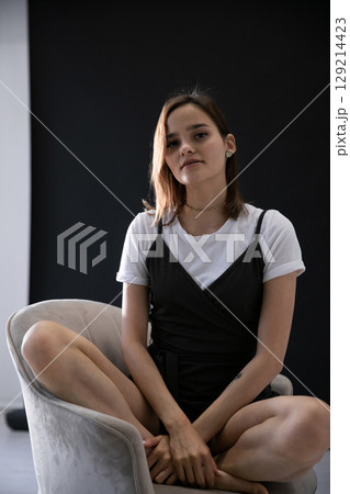 Portrait of a fashionable woman in a black and white summer sundress 129214423
