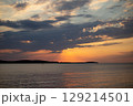 Romantic sunset and sky with calm sea with slight ripples in the background 129214501