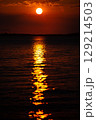 Romantic sunset and sky with calm sea with slight ripples in the background 129214503