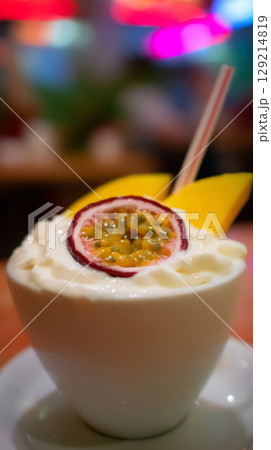 Creamy Dessert Topped with Passion Fruit and Mango Slice. 129214819