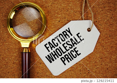Factory Wholesale Price text on price tag with magnifying glass on cork board background Factory Wholesale Price text on price tag with magnifying glass on cork board background 129215411