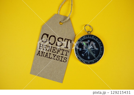 Cost Benefit Analysis text on price tag with compass on cork board background Cost Benefit Analysis text on price tag with compass on cork board background 129215431