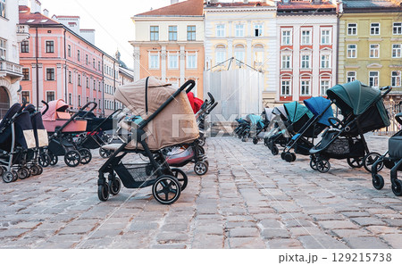 Many empty prams parked on city street 129215738