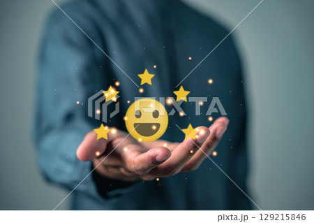 Customer feedback shows stars and smiling icons a great review demonstrating satisfaction, take a moment to review performance and see the business growing with amazing surveys 129215846