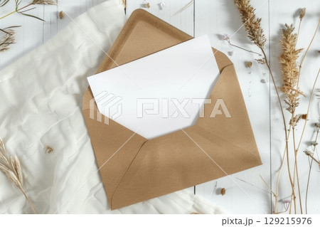 A typical brown envelope containing a separate white card inside of it. AI-generated content. A typical brown envelope containing a separate white card inside of it. AI-generated content. 129215976