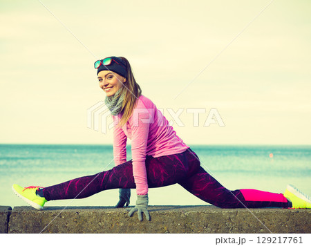 Woman fitness sport girl training outdoor in cold weather 129217761