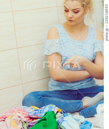 Woman sorting clothes for washing 129218033