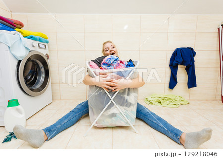 Woman with big basket of dirty clothes laundry. 129218046