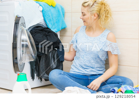 Woman doing black clothes laundry 129218054