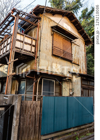 古い昭和建築、トタン作りの錆びた一軒家、鬱蒼とした二階建て狭小住宅 古い昭和建築、トタン作りの錆びた一軒家、鬱蒼とした二階建て狭小住宅 129218086