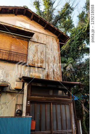 古い昭和建築、トタン作りの錆びた一軒家、鬱蒼とした二階建て狭小住宅 古い昭和建築、トタン作りの錆びた一軒家、鬱蒼とした二階建て狭小住宅 129218088