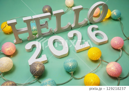 Hello 2026 alphabet letter with LED cotton balls on green background Hello 2026 alphabet letter with LED cotton balls on green background 129218237