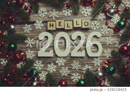 Hello 2026 alphabet letters with Christmas decoration on wooden background 129218425