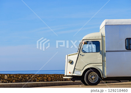 Vintage caravan camping on coast 129218460