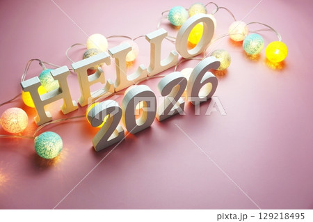 Hello 2026 alphabet letter with cotton ball LED decoration on pink background 129218495