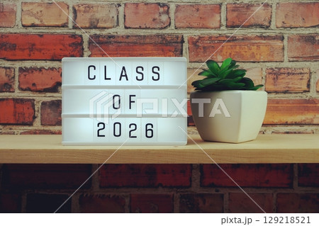 Class of 2026 alphabet letter on wooden background Class of 2026 alphabet letter on wooden background 129218521