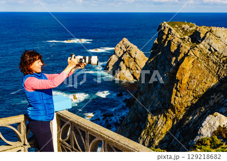 Tourist with camera on Asturias coast, Spain Tourist with camera on Asturias coast, Spain 129218682