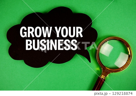 Grow Your Business text with speech bubble and magnifying glass on green background 129218874
