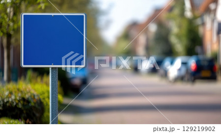 Urban Street Scene with Blue Sign and Row of Parked Vehicles Urban Street Scene with Blue Sign and Row of Parked Vehicles 129219902