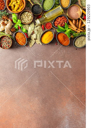 A colorful assortment of fragrant herbs and spices on a warm brown background, showcasing their visual variety and aromatic appeal A colorful assortment of fragrant herbs and spices on a warm brown background, showcasing their visual variety and aromatic appeal 129220903