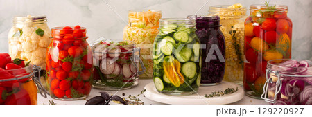 Fresh vegetables like cabbage, tomatoes, cucumbers and radishes, onions, corn, peppers and cauliflower, fermenting naturally to boost health and preserve nutrients, banner Fresh vegetables like cabbage, tomatoes, cucumbers and radishes, onions, corn, peppers and cauliflower, fermenting naturally to boost health and preserve nutrients, banner 129220927
