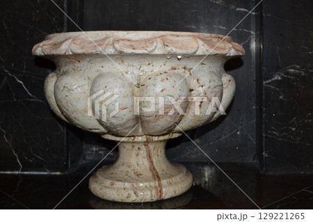 Stone basin in a sauna in the old classical style on a black background Stone basin in a sauna in the old classical style on a black background 129221265