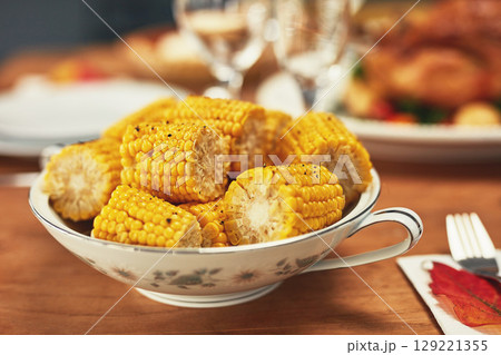 Corn, celebration and dinner on a table for Christmas, lunch and nutrition on holiday. Feast, Thanksgiving and food on a dining table for healthy eating, sharing and celebrate festive with a meal 129221355