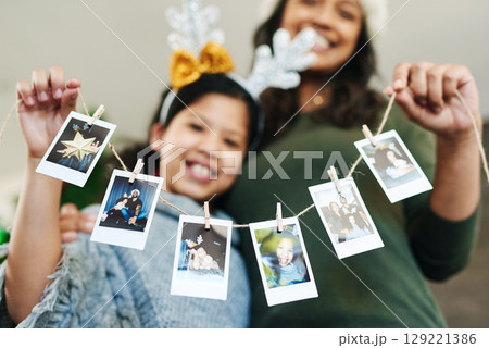 Mother, child and christmas photo garland for family tree decoration for holiday celebration, love and happiness. Woman and girl or daughter in house with photograph or pictures memory banner 129221386