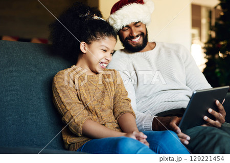 Tablet, video call or movie with black family on christmas for bond, happiness and smile. Care, dad and child on sofa for festive holiday internet streaming together in happy family home. 129221454